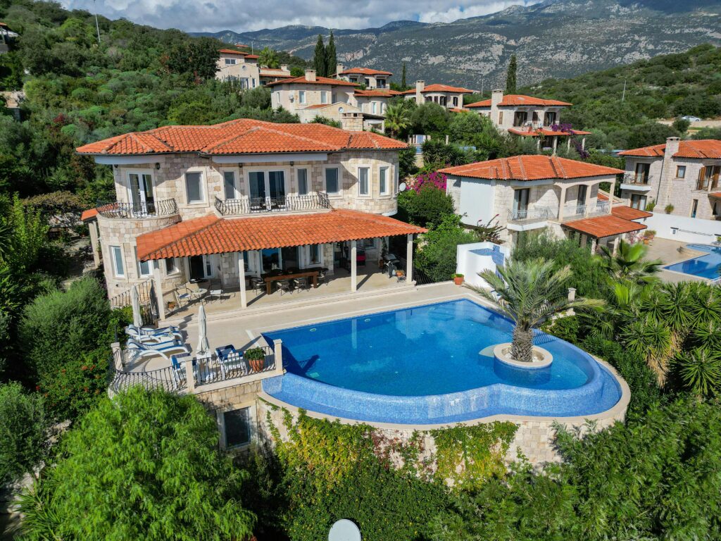 Luxury Mediterranean villa with scenic infinity pool and mountain views.