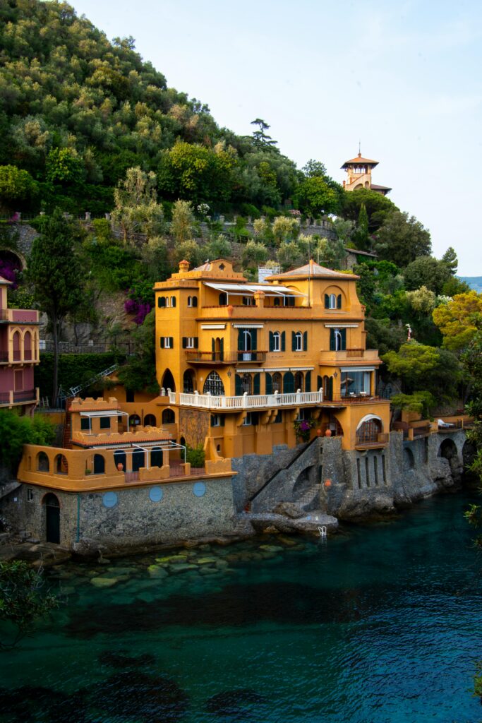 Elegant coastal villa overlooking the Ligurian Sea in Portofino, Italy, showcasing vibrant architecture and lush greenery.